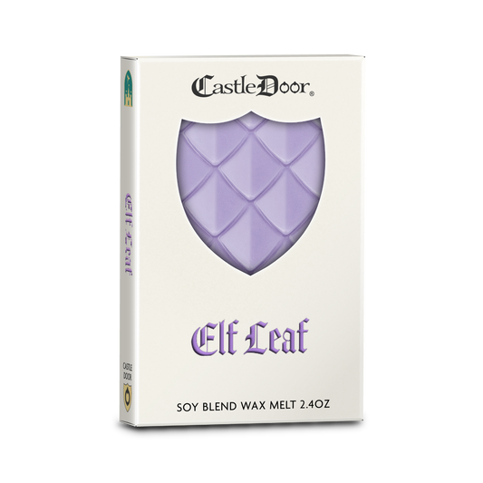 Castle Door Elf Leaf dragonscale wax melt in white book-style packaging, with lavender-purple dragonscale wax visible through a shield-shaped window.