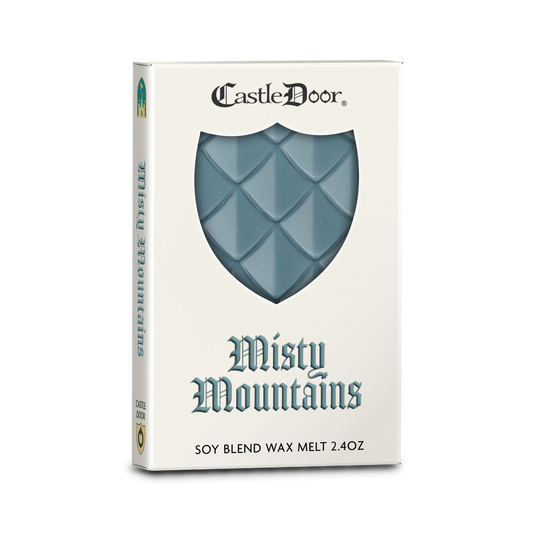 Castle Door Misty Mountains dragonscale wax melt in white book-style packaging, with misty blue dragonscale wax visible through a shield-shaped window.
