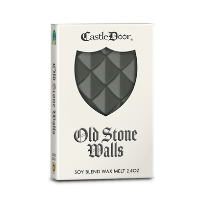 Castle Door Old Stone Walls dragonscale wax melt in white book-style packaging, with dark gray-green dragonscale wax visible through a shield-shaped window.