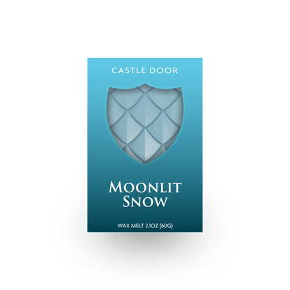 Front packaging of Castle Door Moonlit Snow wax melt, featuring icy blue dragonscale wax visible through a shield-shaped window.