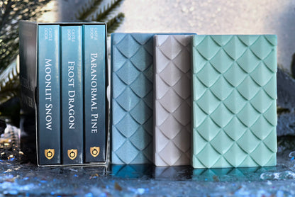 Eternal Winter Wax Melt Trilogy with Frost Dragon and Paranormal Pine boxes beside blue, white, and green dragonscale wax melt snap bars.